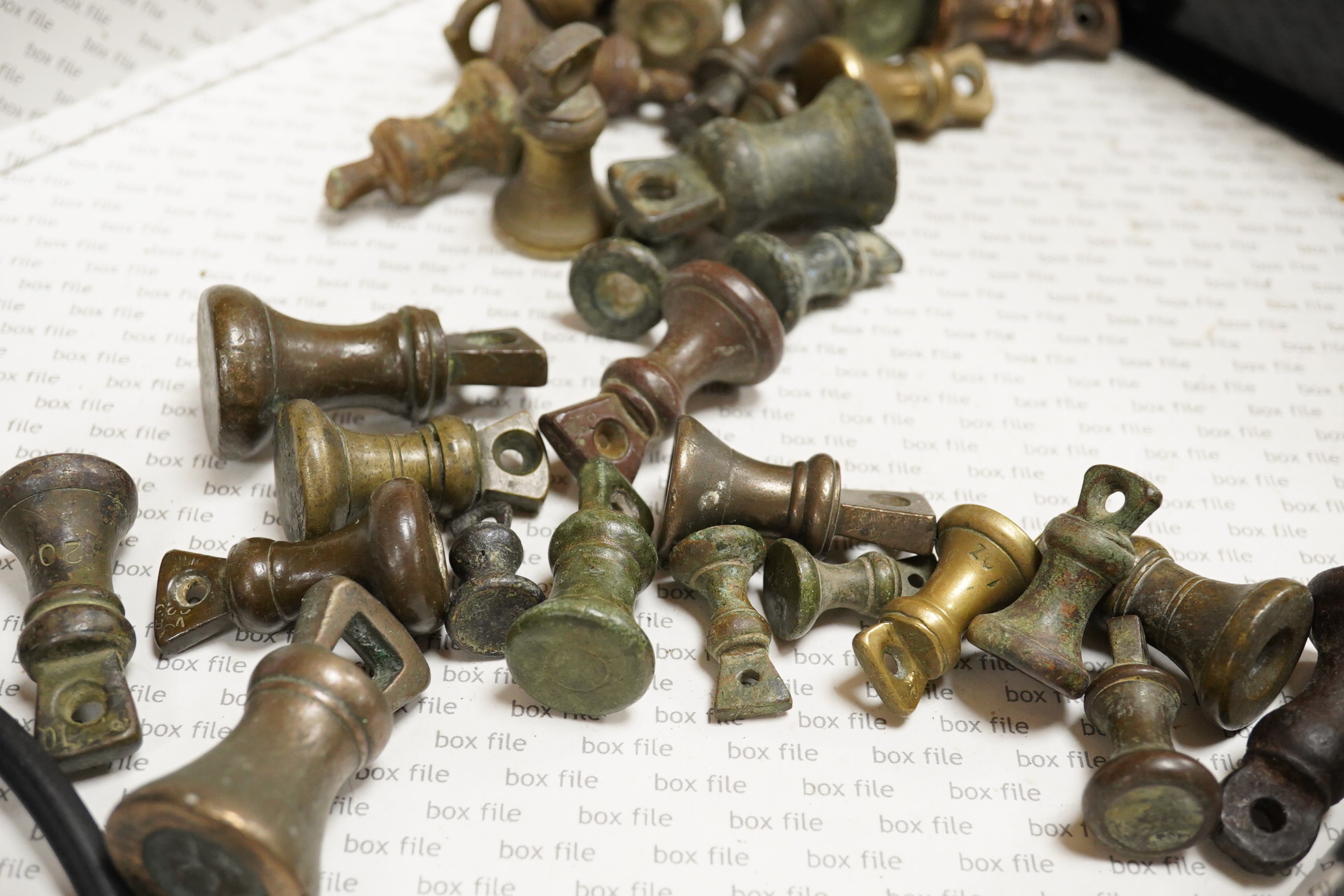 A collection of mainly 18th and 19th century bronze imperial circular trade weights and bell weights, stamped with Royal Cyphers, weights, the dagger assay mark for London, other proof marks, etc., contained within two b